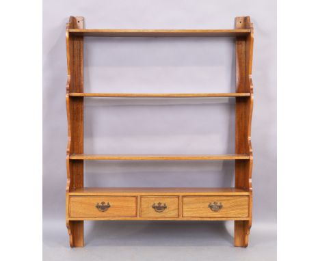 A large George III style mahogany wall hanging shelf, 20th century, with four tiers and three drawers, 122cm high, 94cm wide,