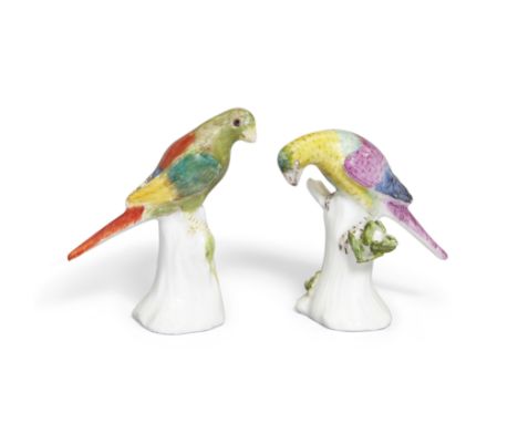 Two Meissen miniature models of parakeets, c.1741, modelled by J.J. Kändler, each perched on a tree-stump, with brightly colo