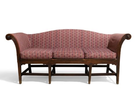 A George III and later mahogany camel back sofa, c.1800, reeded out scrolling armrests, raised on reeded square tapered legs,