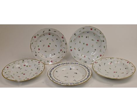 A group of five porcelain soup plates, 19th century, possibly Paris, decorated with scattered flowers with gilded rims, to in