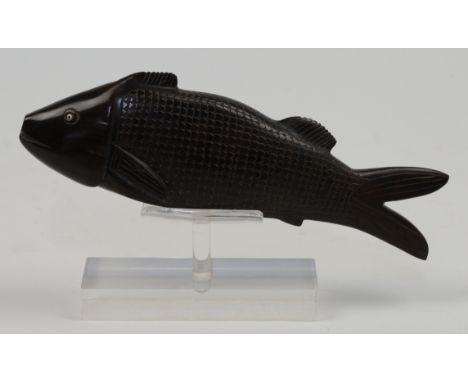 A Chinese carved hardwood model of a fish, 20th century, with inset bead eyes, one lacking, on Perspex display stand, 24cm lo