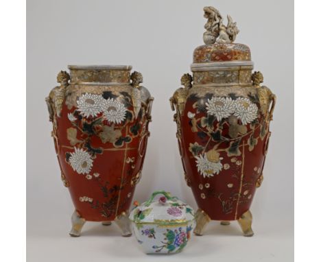 A pair of Japanese satsuma style vases, 20th century, each with applied twin phoenix lugs and raised on tripod feet, the bodi
