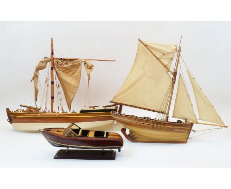 Three model wood boats, 20th century, comprising: a multi-sail yacht with moveable rudder, 50cm high; a cannon boat with whit