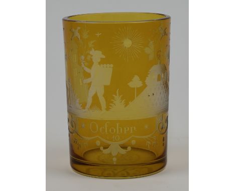 A Bohemian astrological amber flashed glass beaker, 19th century, cut with a detailed symbolic stylised landscape, featuring 