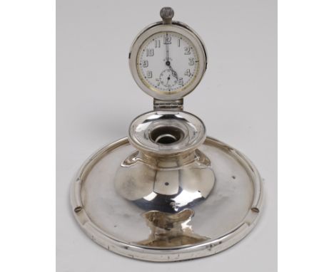 A silver inkstand, Birmingham, 1924, makers mark rubbed, the hinged lid engraved M and enclosing a broken glass inkwell and a