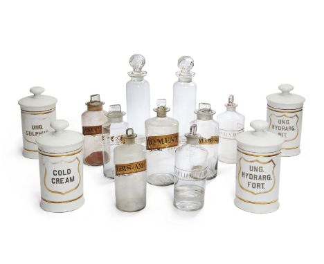 A group of ceramic and glass apothecary jars and bottles, 19th century, comprising: four ceramic jars each with gilt shield c