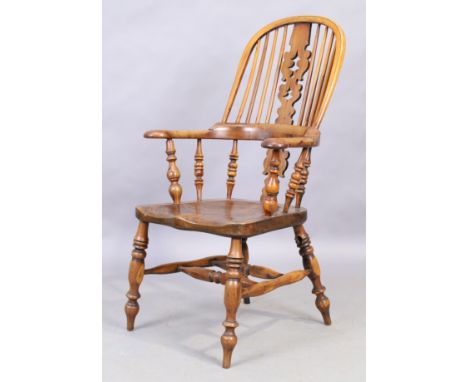 An English elm and yew wood Windsor chair, 19th century, with splay and stick back, turned supports and legs, joined by stret