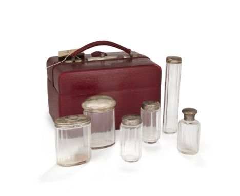 A burgundy leather travelling vanity case fitted with five silver mounted glass bottles, London, 1899 and 1900, Frederick Wic