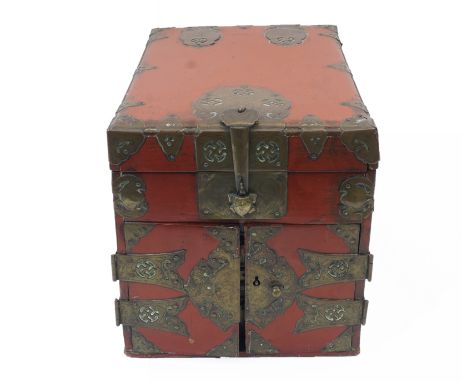 A Chinese red lacquer and brass mounted table top seal chest, early 20th century, the brass mounts with Wan symbols, with hin