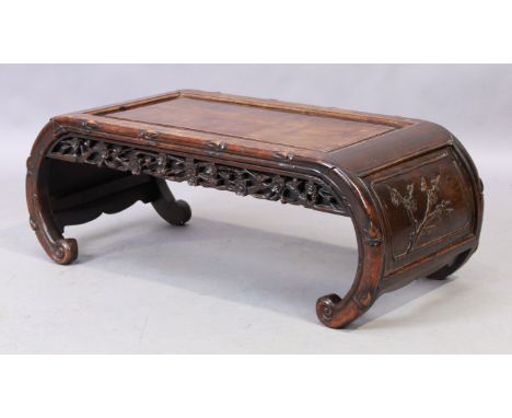 A Chinese Hongmu Kang low table, late 19th century, the scroll ends with floral carvings and floral carved frieze, 33cm high,