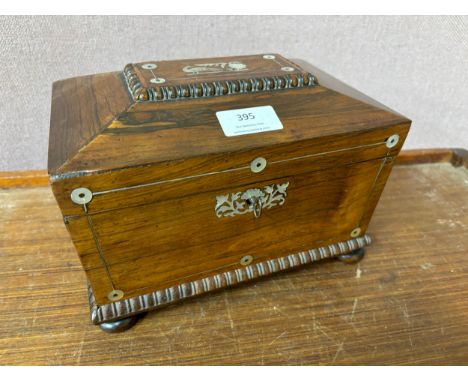 A Regency rosewood and mother of pearl inlaid sarcophagus shaped tea caddy 