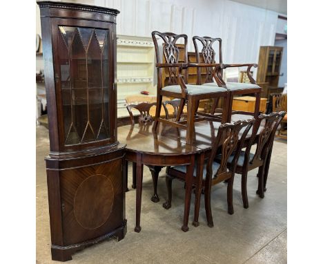 A George III style mahogany D-end dining table, six Chippendale style mahogany dining chairs and Regency style mahogany corne