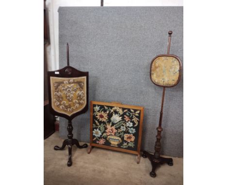 Two Victorian mahogany pole screens and an oak tapestry fire screen 