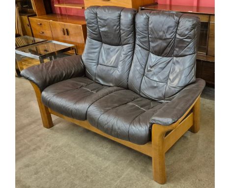 A Norweigan Ekornes teak and brown leather reclining two seater sofa 