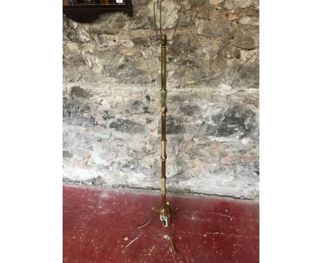 Onyx & brass standard lamp on tri-leg supports 