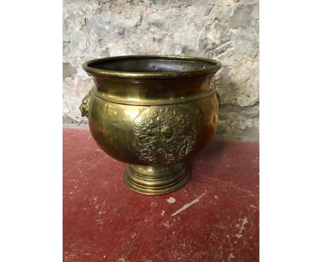 Antique brass planter decorated with crest to the front and lion heads to the sides. 