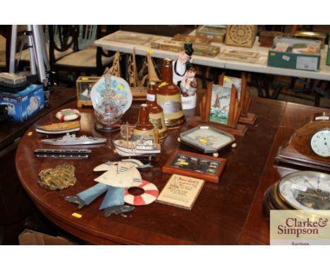 A pair of Art Deco picture frames and contents of signed oils of boats at sea together with Bells Scotch whiskey decanters; h