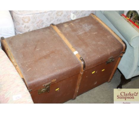 A brass and wooden bound traveling trunk