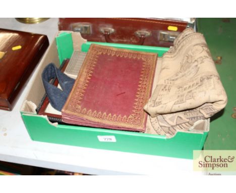 A box with two framed military photo portraits; a woven Belgium tapestry and various other vintage items