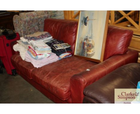 A red leather two seater settee