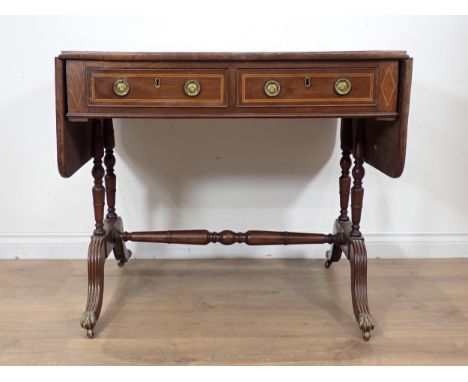 A 19th Century mahogany and rosewood crossbanded Sofa Table fitted two frieze drawers mounted upon cheval base with brass paw