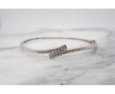 A Diamond hinged Bangle the front with crossover effect channel-set brilliant-cut stones, unmarked, approx 6.70gms 