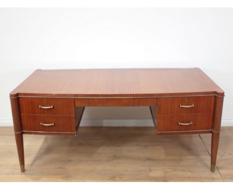 A Mid Century modern 1950's Voltaire mahogany Partner's Desk, fitted four drawers to the one side and two cupboards to the ot