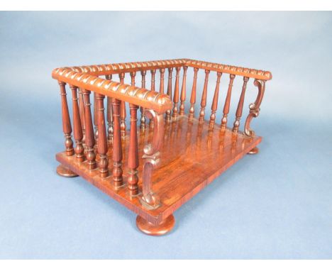 A 19th Century rosewood Book Rest with bobbin turned moulding above spindle frieze fronted by scroll supports, on flat turned