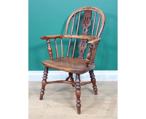 An early 19th Century Child's yew wood Windsor Elbow Chair with pierced burr splat and stick back, solid seat on turned legs 