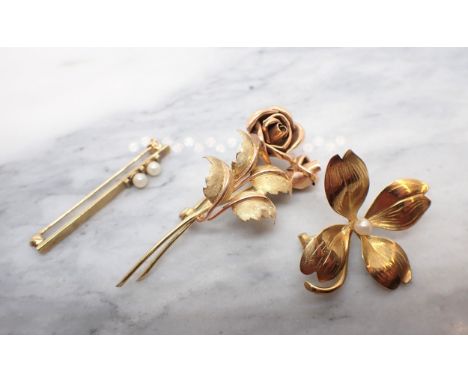 A gold Rose Spray Brooch. Continental marks, a four leafed Clover Brooch set seed pearl and a 9ct gold Bar Brooch set two cul