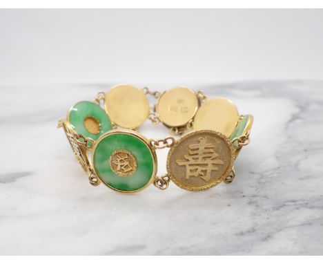 A Chinese Jade Bracelet having gold discs embossed characters, three of these mounted jade circles on hidden clasp, Chinese m
