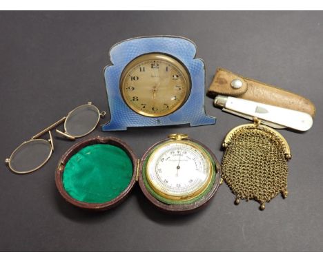 An 8 day Alarm Clock in blue enamel surround, the cream dial with arabic numerals, movement marked BREVET, on easel stand, a 