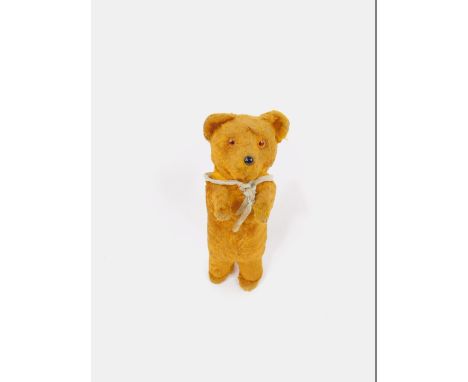 An early 20thC Golden Mohair Teddy Bear, with glass eyes and black button nose, compressable body, 17cm high.