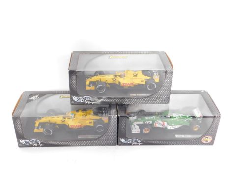 Three Hotwheels model racing cars, scale 1:18, comprising Jordan EJ12, Takuma Sato; Jaguar Racing R2, Eddie Irvine; and Jorda