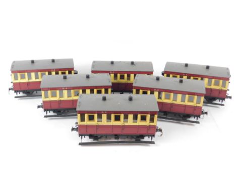 Six large scale model railway coaches, red livery.