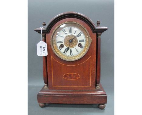 An Early XX Century Mahogany and Satinwood Inlaid Mantle Clock, the arched case with side columns and raised on bun feet, the