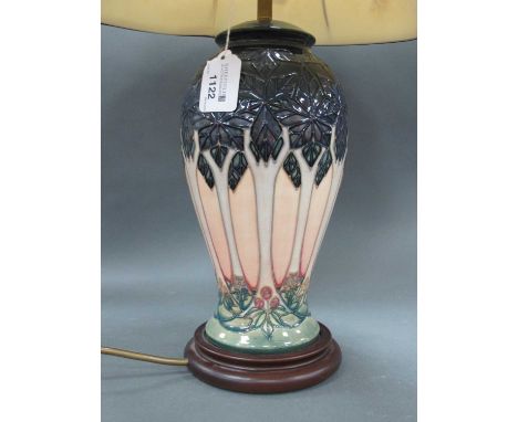 A Moorcroft Pottery Table Lamp, of ovoid shape, painted in the 'Cluny' pattern with blue angular leaves to top on a peach bod