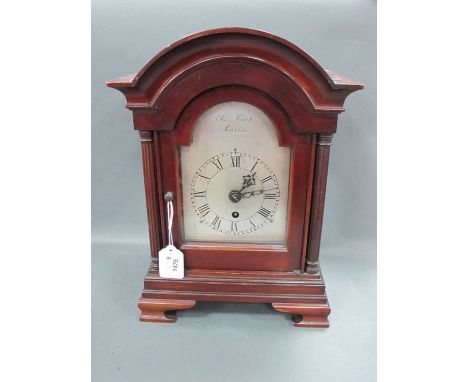 An Early XX Century Mahogany Cased Mantle Clock, the arched top above reeded column and stepped base with bracket feet, the s
