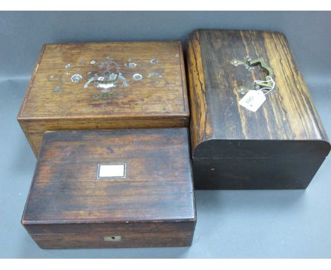 A Mid Victorian Coromandel Sewing Box, the shaped lid with brass handle, red velvet interior, 30cm long and two rosewood sewi