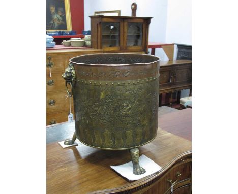 An Early XX Century Brass and Copper Circular Log Bin, with lion ring handles and engraved foliate decoration on paw feet, 35
