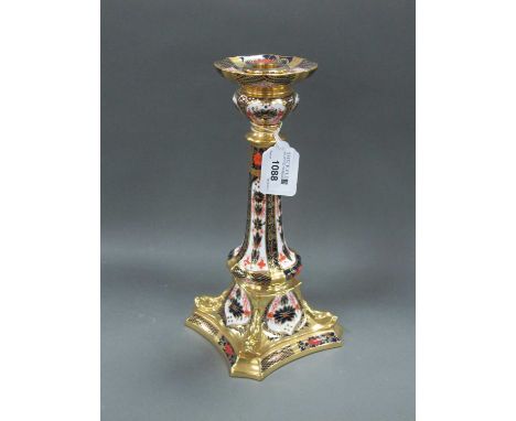 A Royal Crown Derby Porcelain Candlestick, the square base moulded with dolphins, decorated in Imari pattern 1128, date code 