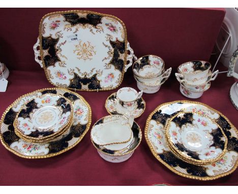 A Coalport Porcelain Part Tea Service, decorated in the blue 'Batwing' pattern with cartouches of flowers, printed marks, com