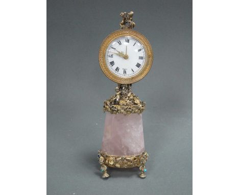 An Early XX Century French Bedroom Clock, the circular gilt metal case stamped "Angelus 17 jewels", the white enamel dial wit