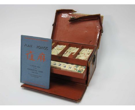 An Early XX Century Mah Jong Set, the leather travelling case with five lift-out trays containing bone and bamboo tiles and s