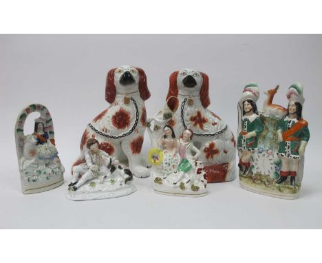 A Pair of Late XIX Century Staffordshire Dogs, with iron red patches, separate moulded front leg and black chains, 26.5cm hig
