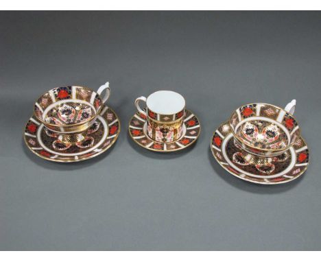 Two Royal Crown Derby Porcelain Teacups and Saucers, decorated in Imari pattern 1128, date codes for 1980, and a matching cof