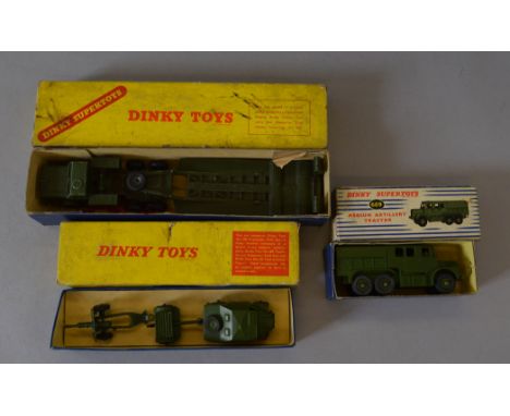 Three boxed Dinky Toys diecast military vehicles, 660 Tank Transporter, F, and 697 25-Pounder Field Gun Set, G, both in F but