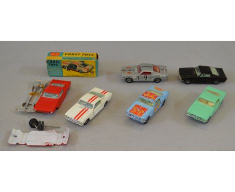 Six Corgi Toys Ford Mustang diecast model cars, including 325 Competition Model white with red stripes, F with P box and four