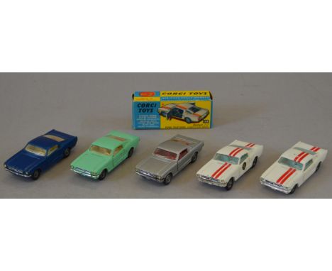 Five Corgi Toys Ford Mustang diecast model cars, including two  325 Competition Models, white with red stripes, F/G with one 