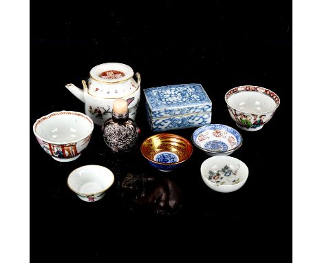 A group of Oriental items, including porcelain tea bowls, unmarked white metal snuff bottle, bronze elephant etc 